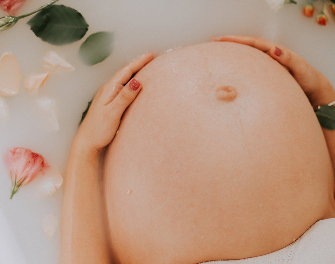 Pregnant Woman Sitting on Bathtub